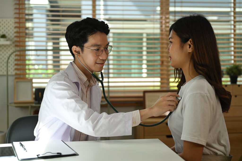 Arzt untersucht eine Patientin mit dem Stethoskop beim Check-up